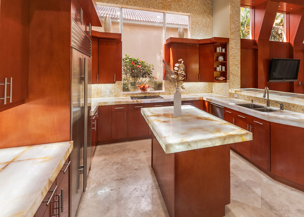 Mid-sized modern u-shaped eat-in kitchen in Miami with a drop-in sink, raised-panel cabinets, light wood cabinets, quartzite benchtops, beige splashback, mosaic tile splashback, stainless steel appliances and with island.