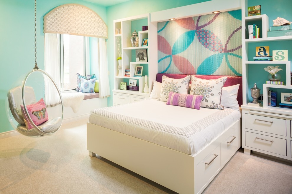 This is an example of a mid-sized contemporary kids' bedroom for girls and kids 4-10 years old in Houston with blue walls, carpet and beige floor.