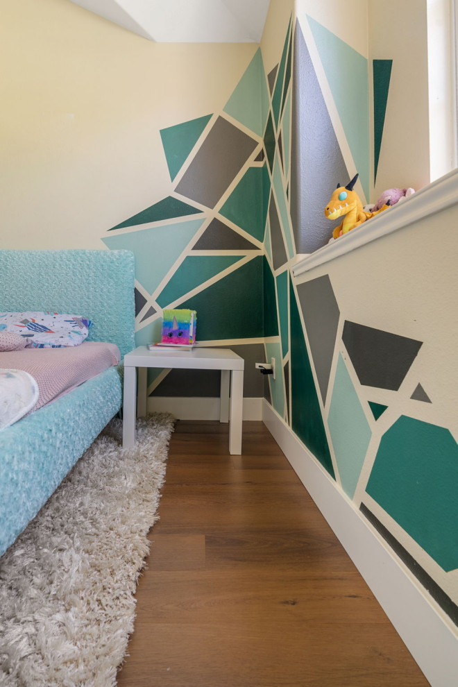 Medium sized traditional children’s room for girls in San Diego with beige walls, vinyl flooring, brown floors and a vaulted ceiling.
