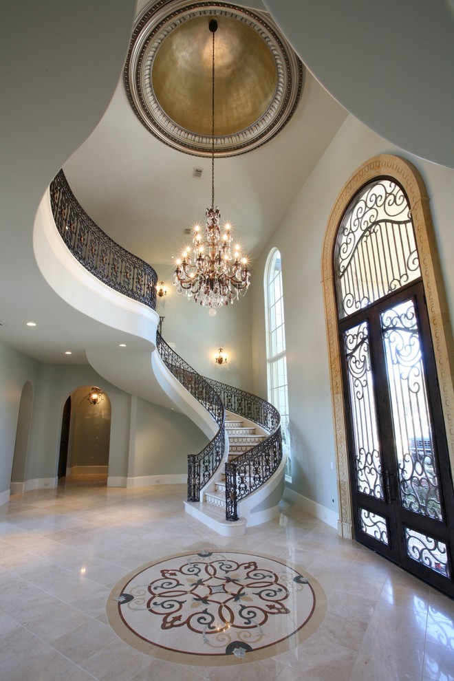 Photo of an expansive traditional foyer in Houston with grey walls and a double front door.