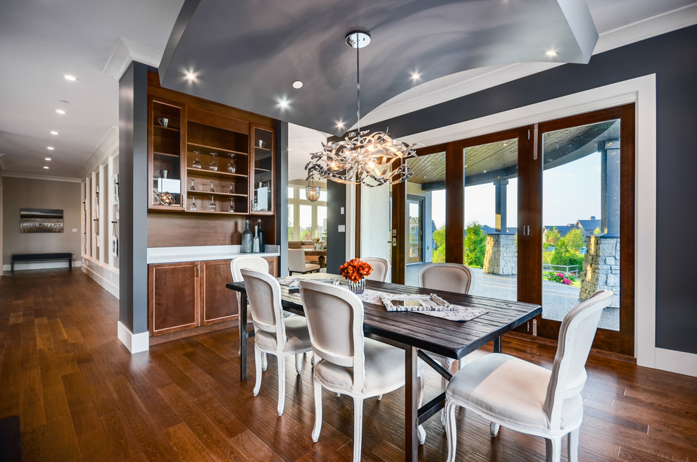 This is an example of a transitional dining room in Vancouver with blue walls and dark hardwood floors.