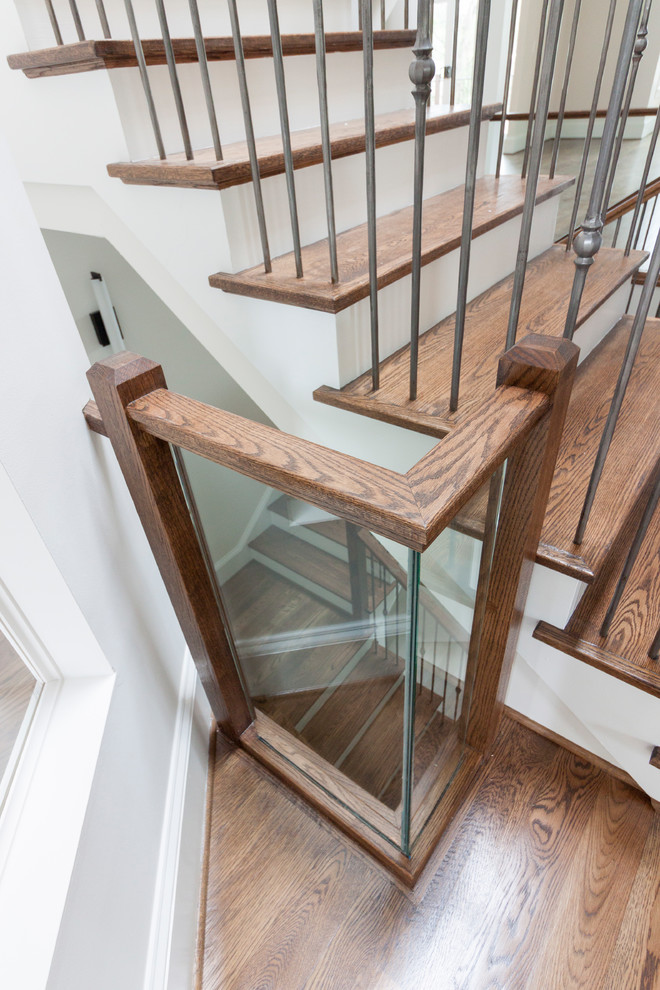 Design ideas for an expansive contemporary wood floating staircase in DC Metro with wood risers and glass railing.