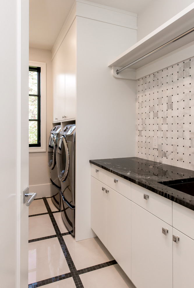 Inspiration for a large transitional single-wall ceramic tile dedicated laundry room remodel in Calgary with an undermount sink, flat-panel cabinets, white cabinets, granite countertops, white walls and a side-by-side washer/dryer