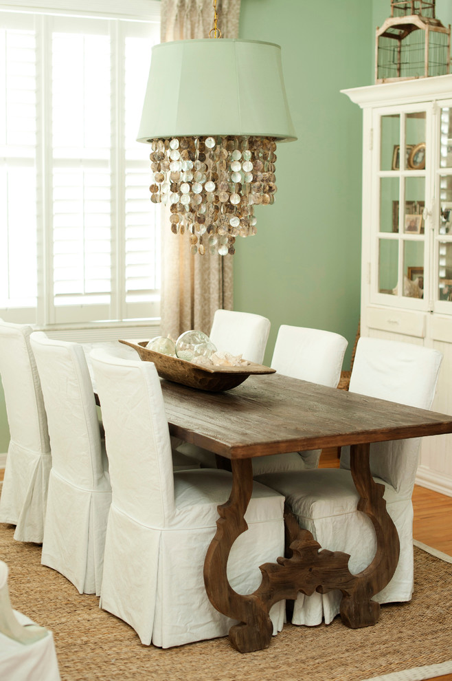 Transitional dining room in Tampa with green walls and medium hardwood floors.