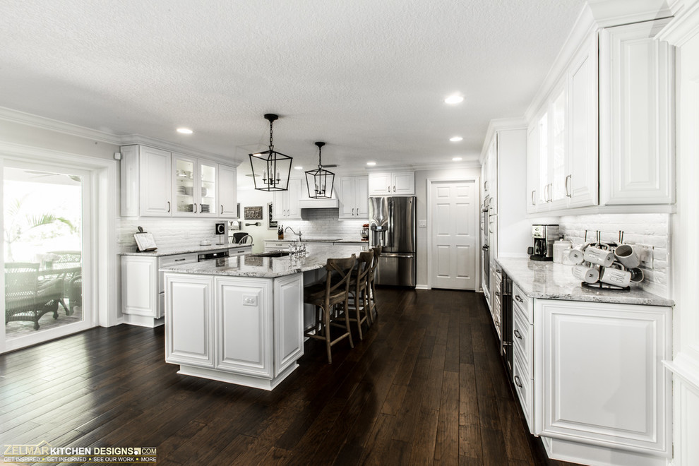 Inspiration for a large traditional u-shaped eat-in kitchen in Orlando with raised-panel cabinets, white cabinets and with island.