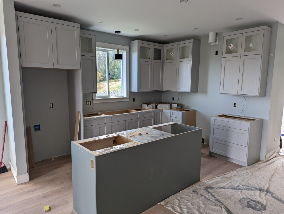 Kitchen renovation with upper cabinets and island being installed
