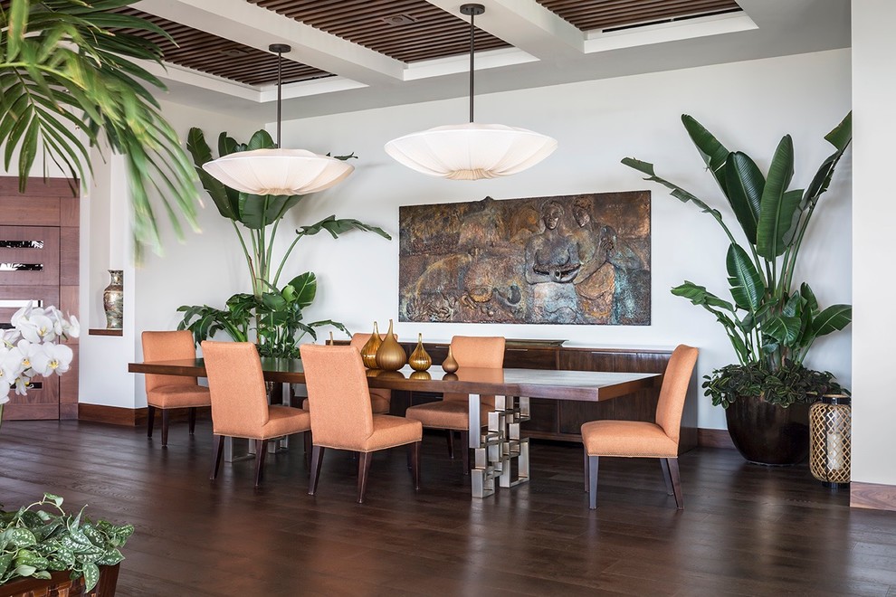 Design ideas for a large tropical open plan dining in Orange County with white walls, dark hardwood floors and no fireplace.