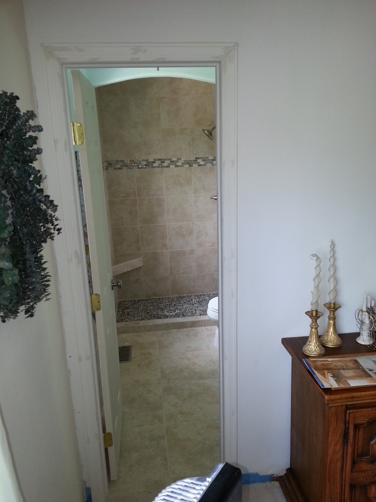 Example of a mid-sized transitional 3/4 beige tile and porcelain tile porcelain tile and beige floor alcove shower design with raised-panel cabinets, white cabinets, a two-piece toilet, blue walls, an undermount sink, laminate countertops, a hinged shower door and multicolored countertops