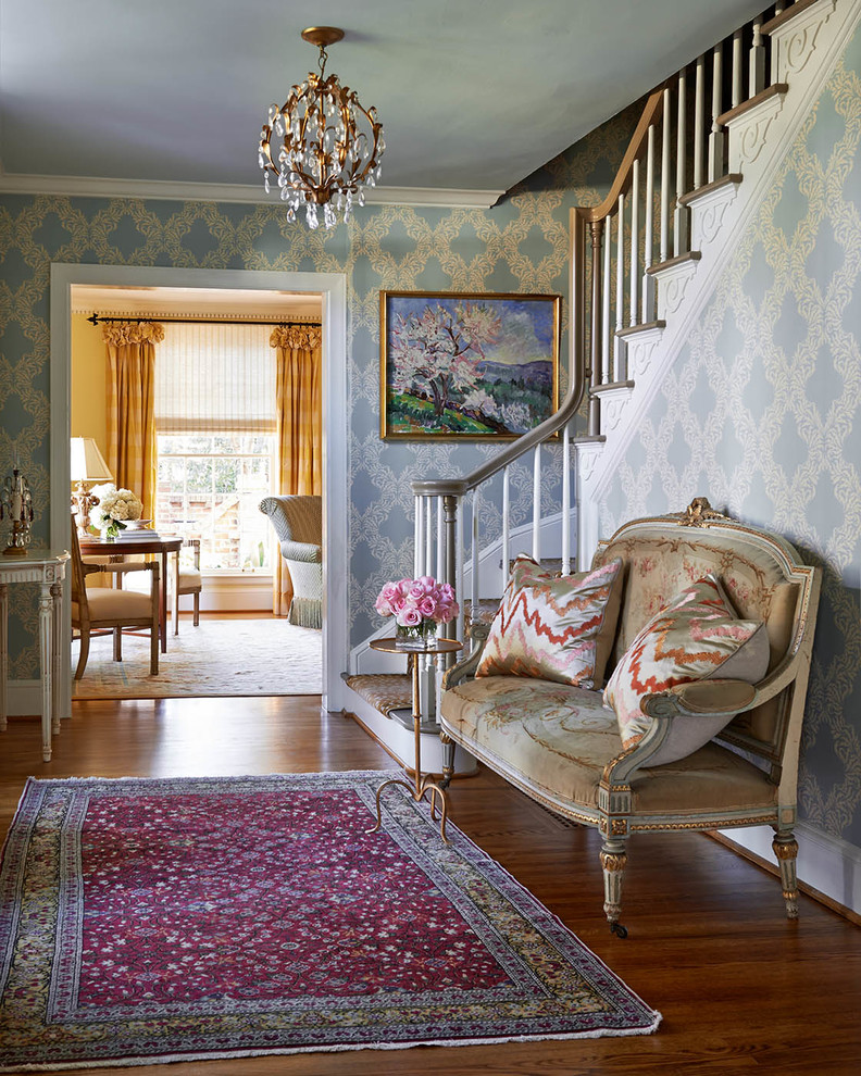 Design ideas for a mid-sized traditional foyer in Charlotte with medium hardwood floors and multi-coloured walls.