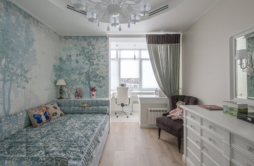 This is an example of a transitional kids' bedroom for girls in Moscow with light hardwood floors, beige floor and blue walls.