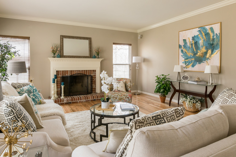 Photo of a family room in St Louis with beige walls, light hardwood floors, a standard fireplace and a brick fireplace surround.