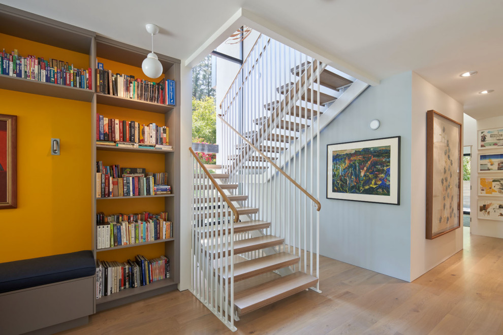 This is an example of a midcentury wood u-shaped metal railing staircase in San Francisco.