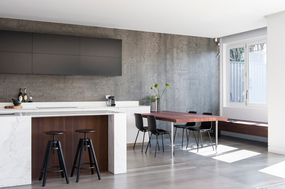 Design ideas for a mid-sized modern l-shaped eat-in kitchen in Sydney with an integrated sink, dark wood cabinets, solid surface benchtops, grey splashback, cement tile splashback, ceramic floors and with island.