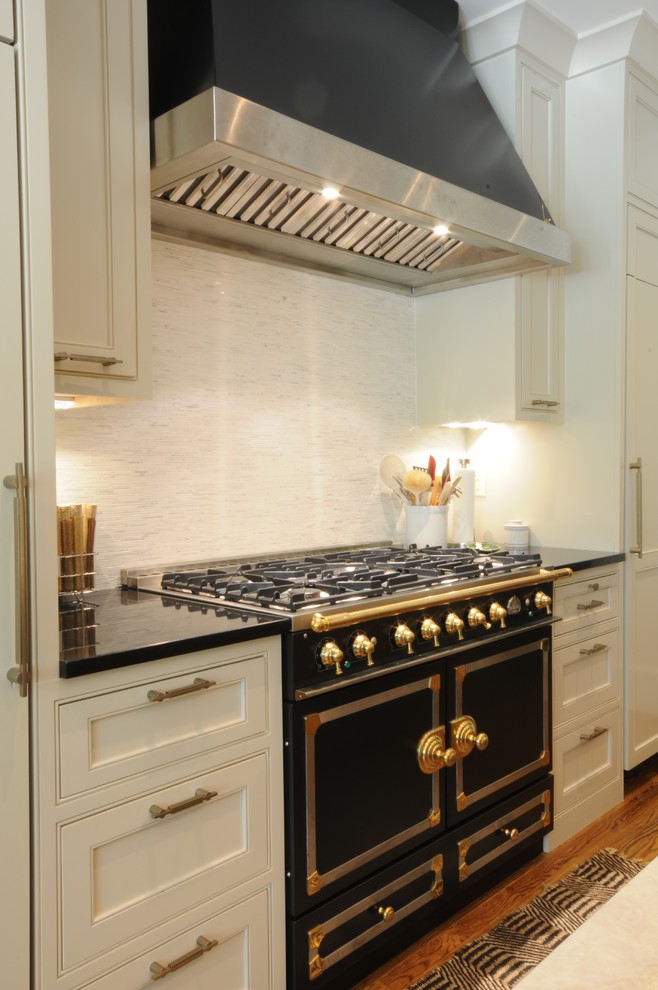 Open concept kitchen - large transitional u-shaped dark wood floor and brown floor open concept kitchen idea in Birmingham with an undermount sink, shaker cabinets, white cabinets, granite countertops, white backsplash, mosaic tile backsplash, paneled appliances and an island
