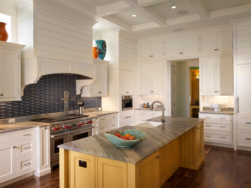 Design ideas for a large contemporary l-shaped eat-in kitchen in Tampa with a single-bowl sink, beaded inset cabinets, yellow cabinets, soapstone benchtops, blue splashback, matchstick tile splashback, stainless steel appliances, dark hardwood floors, with island and brown floor.