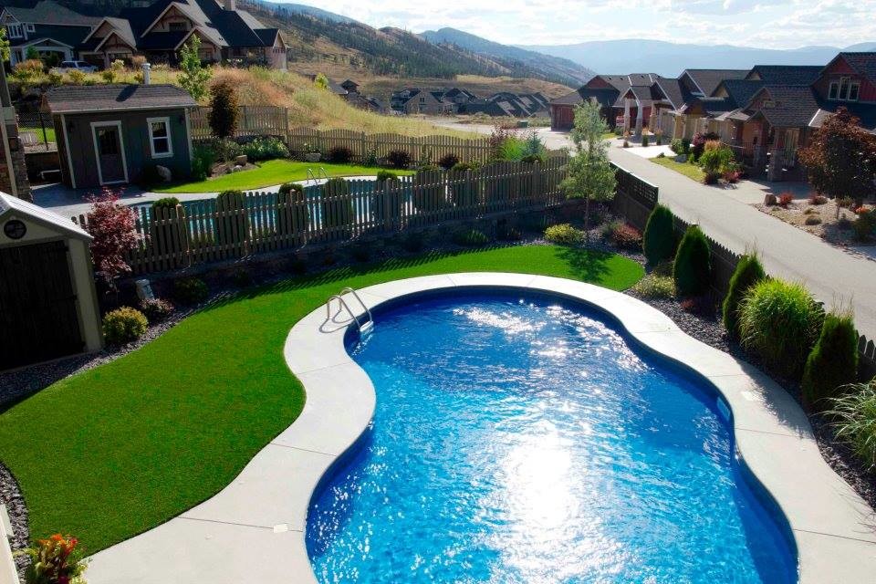 Pool fountain - mid-sized traditional backyard pool fountain idea