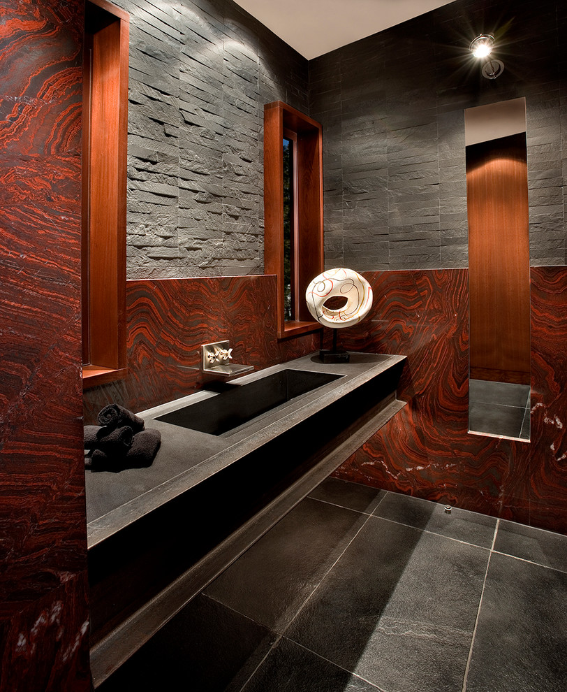 Large modern powder room in Sacramento with black tile, stone slab, red walls, a drop-in sink and grey floor.