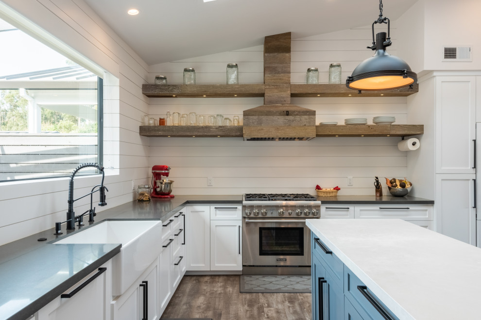 Kitchen - large transitional l-shaped medium tone wood floor and brown floor kitchen idea with a farmhouse sink, shaker cabinets, white cabinets, paneled appliances, an island and gray countertops