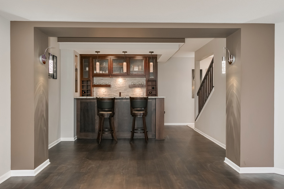 Design ideas for a large transitional walk-out basement in Minneapolis with grey walls, dark hardwood floors, a corner fireplace, a tile fireplace surround and brown floor.