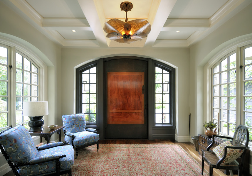 Inspiration for a large asian foyer in Seattle with green walls, dark hardwood floors, a pivot front door and a medium wood front door.