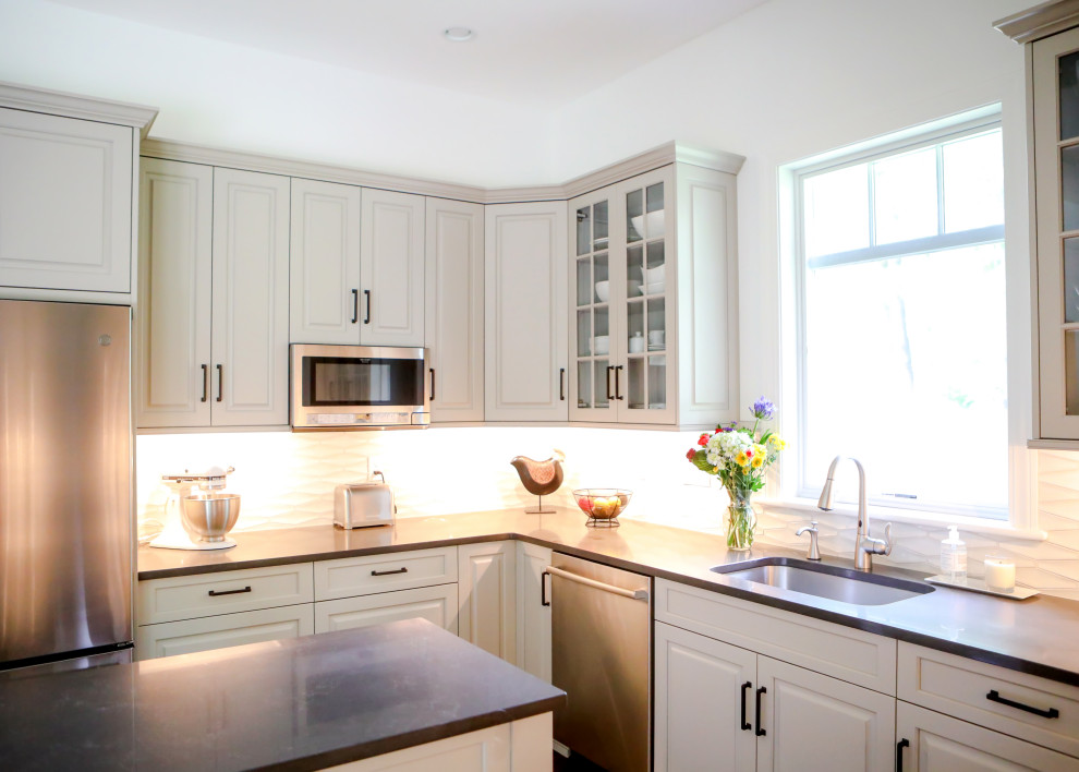 Inspiration for a transitional kitchen remodel with raised-panel cabinets and an island