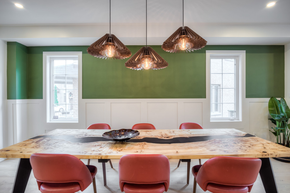 Пример оригинального дизайна: кухня-столовая в скандинавском стиле с зелеными стенами, светлым паркетным полом, стандартным камином, фасадом камина из дерева, бежевым полом и панелями на стенах