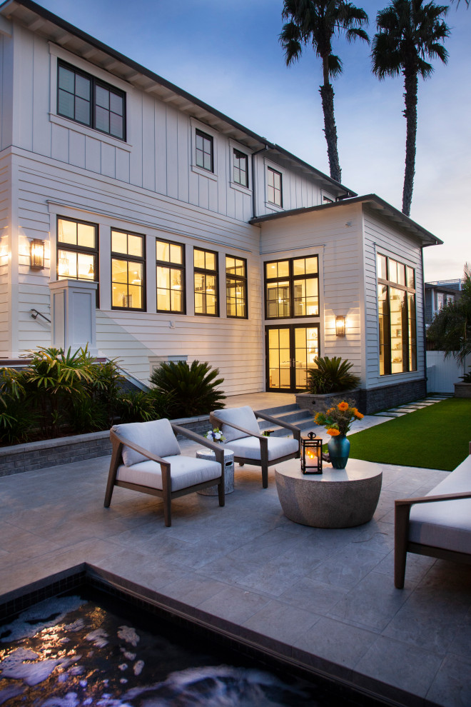 This is an example of a large beach style backyard patio in San Diego.