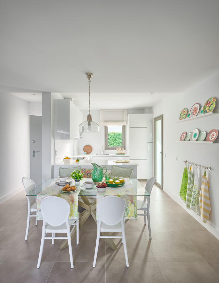 Photo of a mid-sized transitional open plan dining in Malaga with white walls, porcelain floors and grey floor.