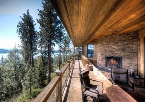 Inspiration for a large rustic deck remodel in Seattle with a fire pit and a roof extension