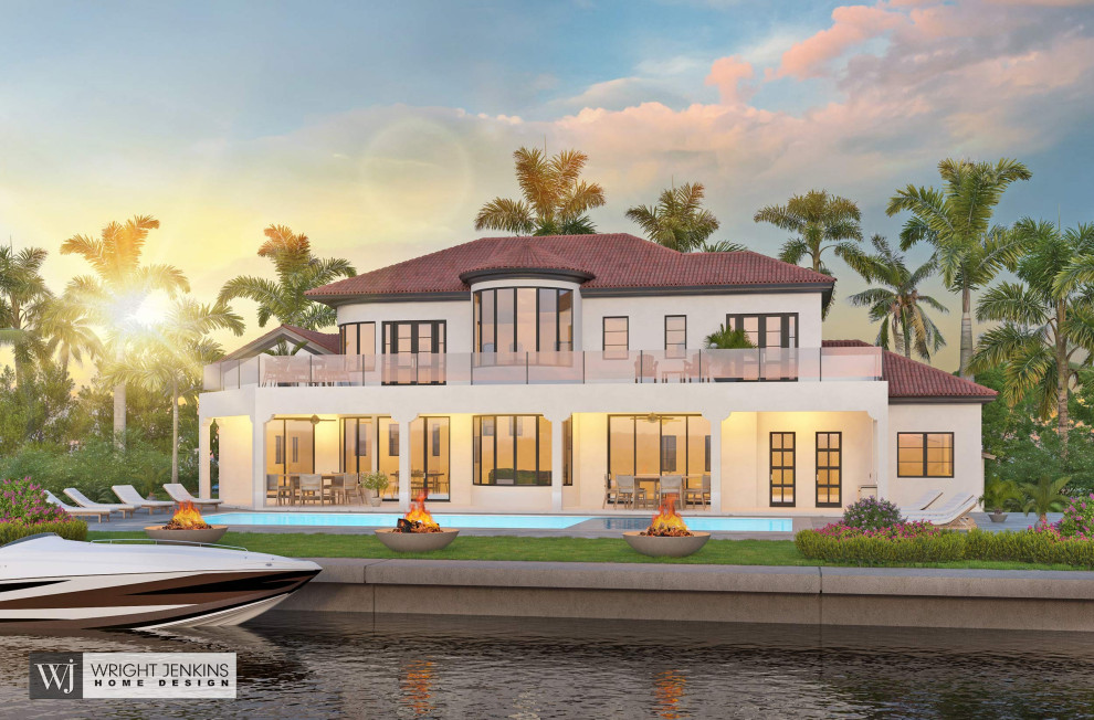 Large beach style two-storey stucco white house exterior in Other with a hip roof, a tile roof and a red roof.