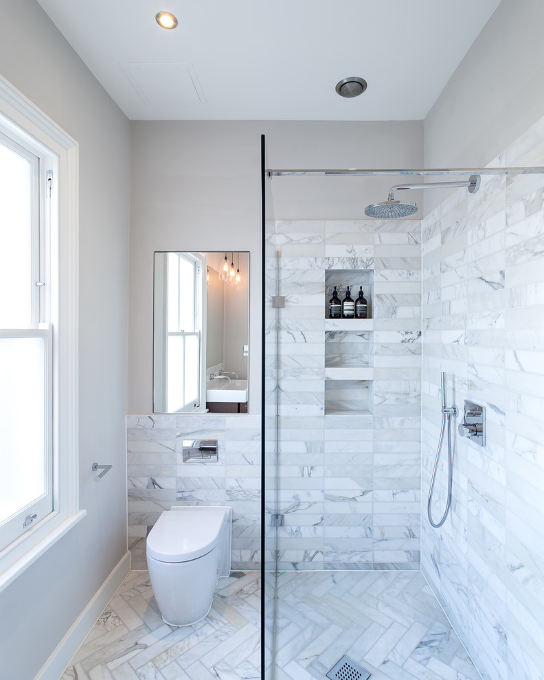 This is an example of a mid-sized contemporary 3/4 bathroom in London with an open shower, white tile, stone tile, white walls, marble floors, a one-piece toilet and an open shower.