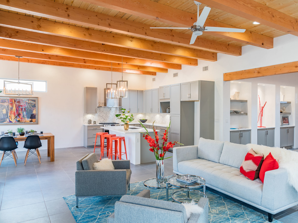 This is an example of a mid-sized contemporary open concept family room in Albuquerque with white walls, porcelain floors, a two-sided fireplace, a stone fireplace surround and grey floor.