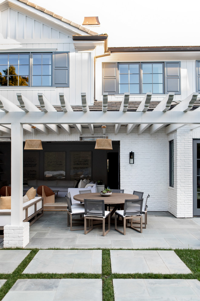 Design ideas for a large modern backyard patio in New York with concrete pavers and a pergola.