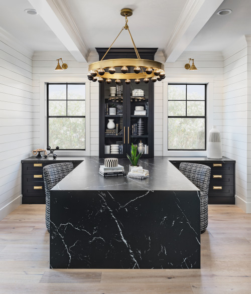 Slabs of black marble-look quartz with a waterfall edge form a dramatic desk in a Scottsdale, Arizona, couple’s home office by K and Q Interiors. Black cabinets, white shiplap walls, a sculptural gold chandelier and an elegant sense of symmetry greatly ease the pain of going to work every day.