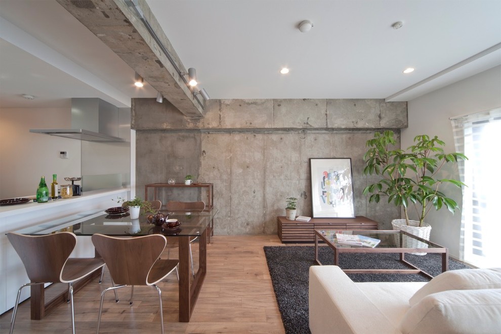 This is an example of a contemporary open plan dining in Other with white walls and light hardwood floors.