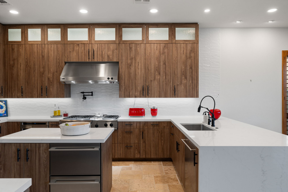 Example of a mountain style l-shaped slate floor and beige floor enclosed kitchen design with a single-bowl sink, flat-panel cabinets, medium tone wood cabinets, quartzite countertops, white backsplash, glass sheet backsplash, stainless steel appliances, a peninsula and white countertops