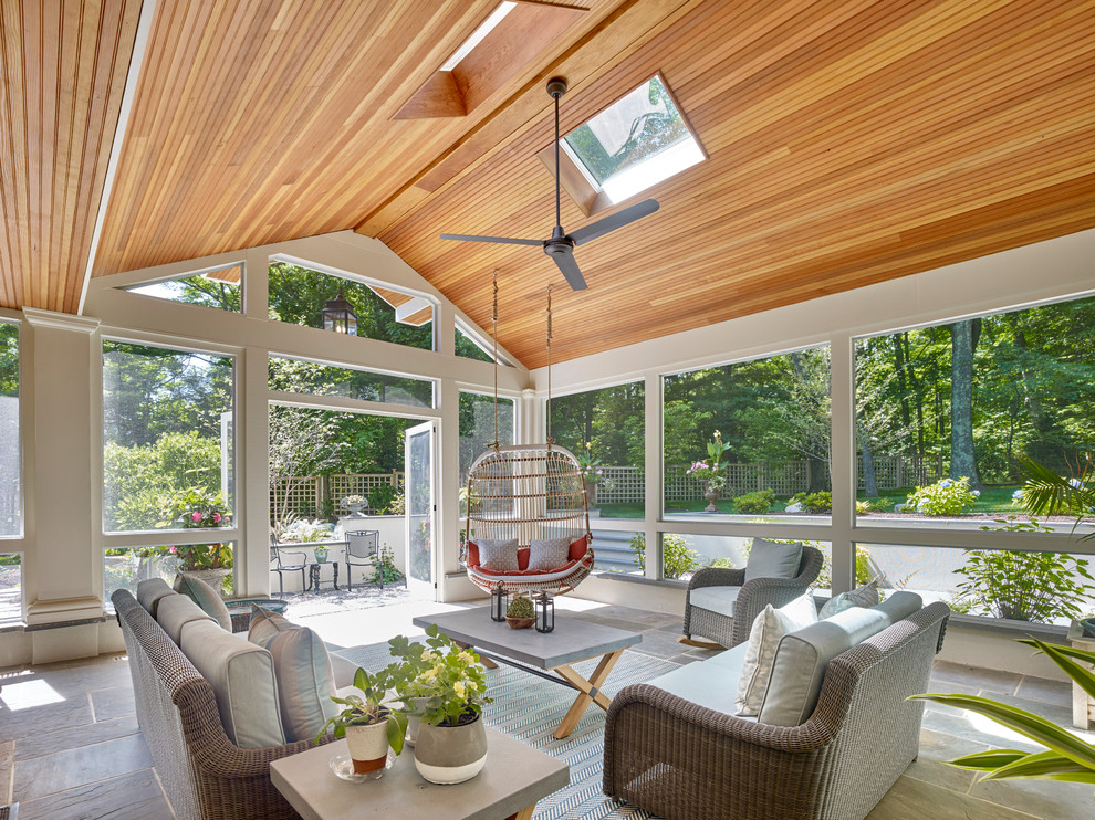 Photo of an expansive traditional sunroom in New York with a skylight and multi-coloured floor.