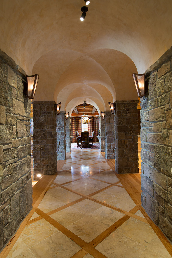 Photo of a mid-sized country hallway in Jackson with multi-coloured walls, marble floors and beige floor.