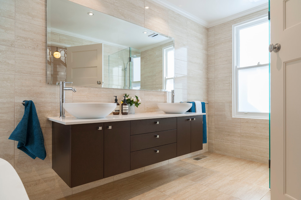 Inspiration for a small contemporary master bathroom in Melbourne with a vessel sink, flat-panel cabinets, dark wood cabinets, marble benchtops, a freestanding tub, an open shower, a two-piece toilet, beige tile, beige walls and porcelain floors.