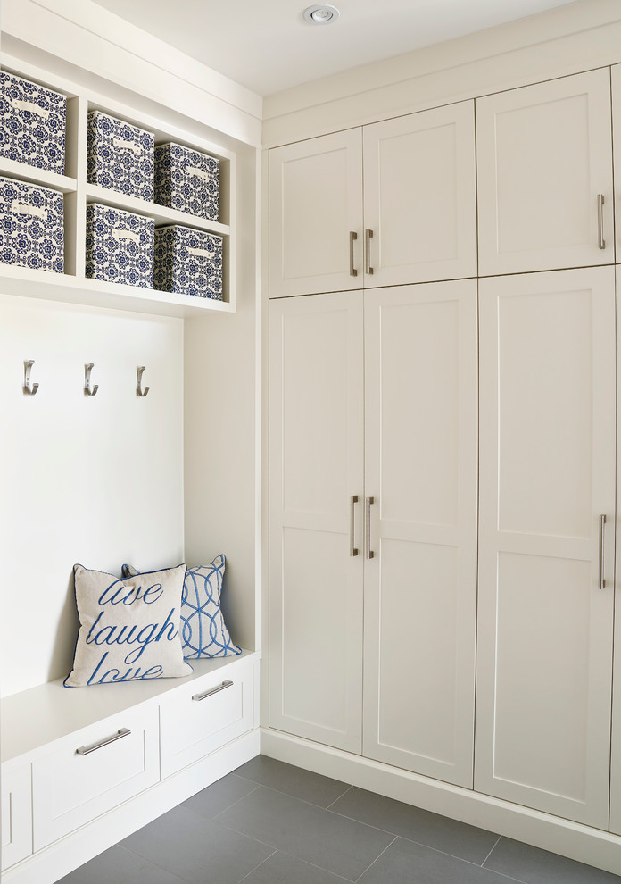 Inspiration for a mid-sized transitional ceramic tile foyer remodel in Toronto with white walls and a dark wood front door