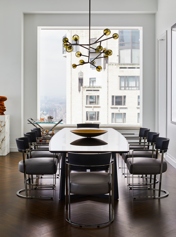 Inspiration for a contemporary dining room in London with white walls, dark hardwood floors and brown floor.