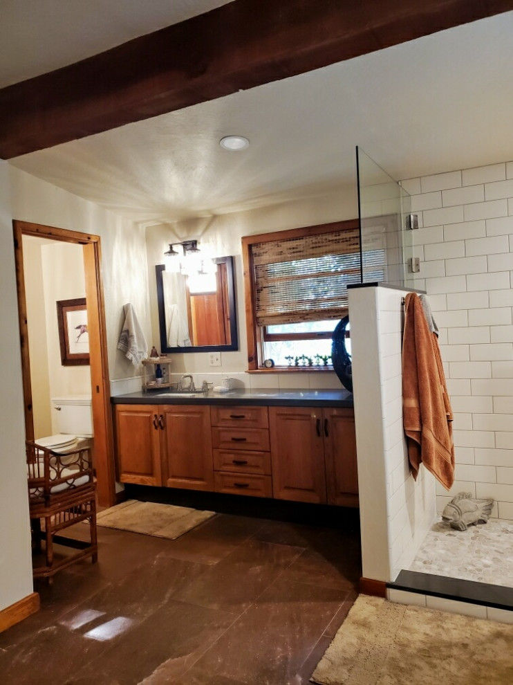 Inspiration for a large traditional master bathroom in Other with raised-panel cabinets, light wood cabinets, a freestanding tub, an open shower, a two-piece toilet, beige tile, ceramic tile, beige walls, porcelain floors, an undermount sink, engineered quartz benchtops, red floor, an open shower, grey benchtops, a niche, a double vanity, a built-in vanity and exposed beam.
