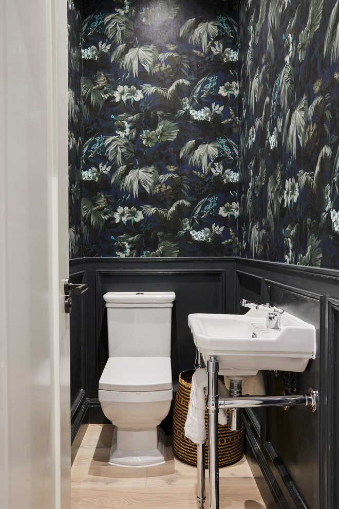 Design ideas for a transitional powder room in London with multi-coloured walls, a console sink and beige floor.