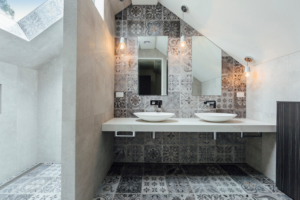 Photo of a mid-sized contemporary master bathroom in Sydney with an open shower, gray tile, stone tile, grey walls, cement tiles, a vessel sink, marble benchtops and an open shower.