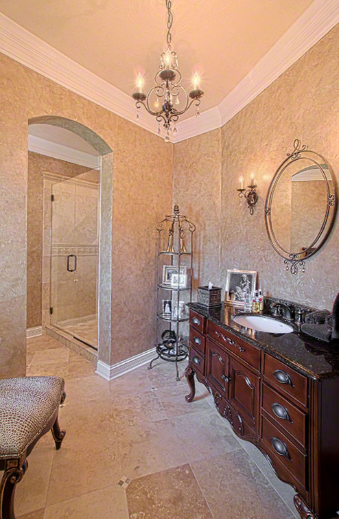 Design ideas for a mid-sized traditional master bathroom in Dallas with raised-panel cabinets, dark wood cabinets, an alcove shower, a one-piece toilet, brown tile, beige walls, travertine floors, an undermount sink, engineered quartz benchtops, beige floor and a hinged shower door.