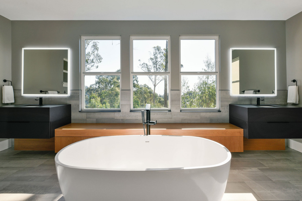 Photo of a mid-sized modern bathroom in San Francisco with furniture-like cabinets, black cabinets, an alcove shower, a one-piece toilet, an undermount sink, solid surface benchtops, a hinged shower door and black benchtops.