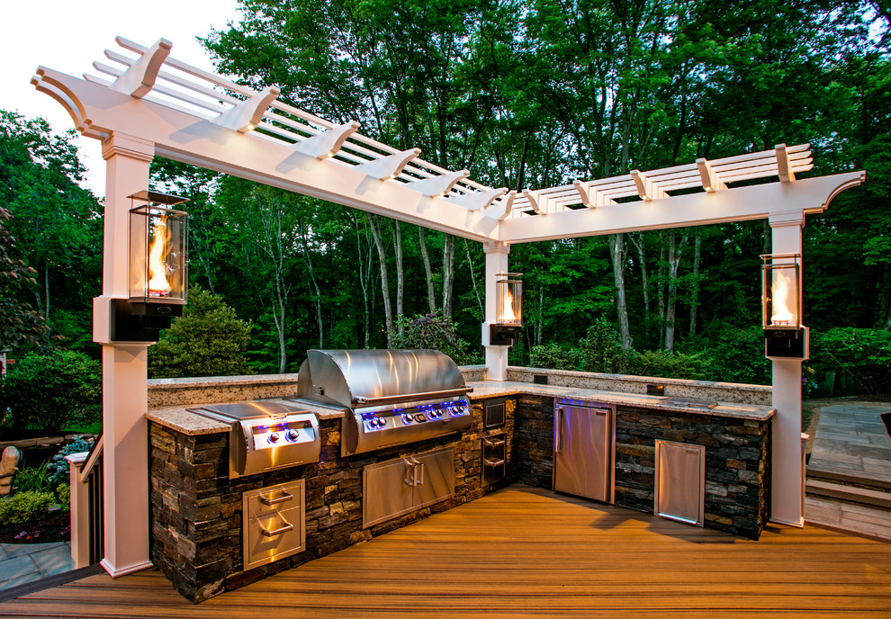 Design ideas for a large transitional backyard deck in Seattle with a fire feature and a pergola.