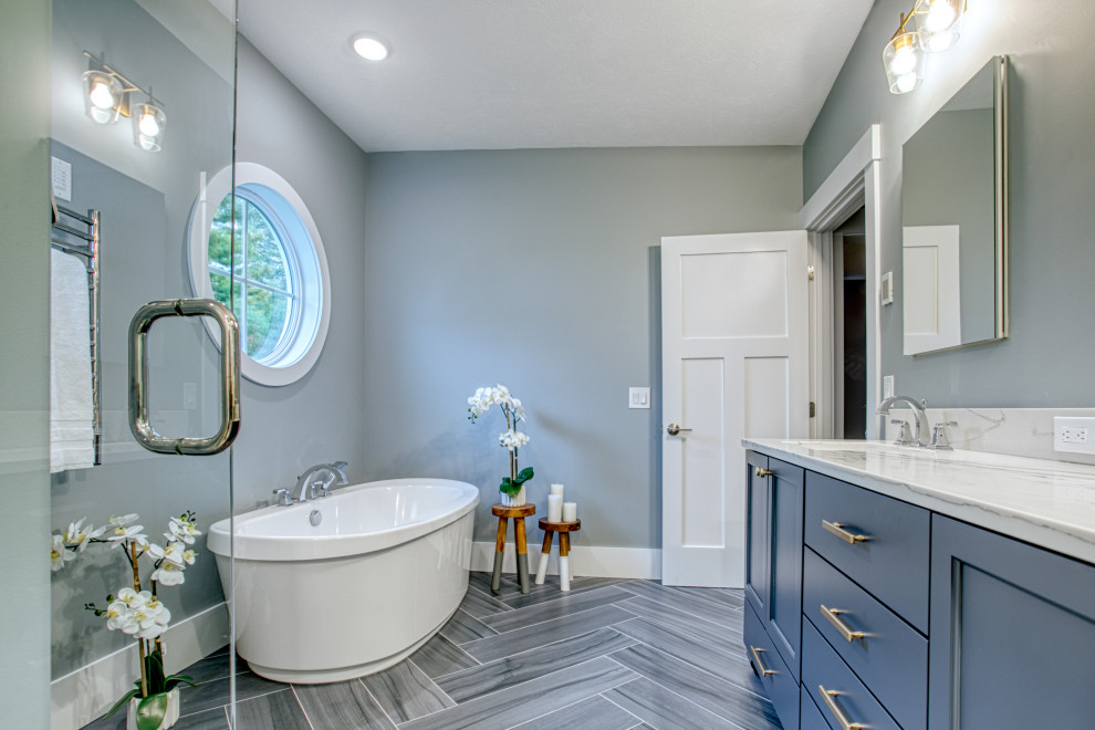 Inspiration for a large traditional master bathroom in Other with recessed-panel cabinets, blue cabinets, a freestanding tub, a corner shower, grey walls, an undermount sink, grey floor, a hinged shower door, grey benchtops, a double vanity and a built-in vanity.