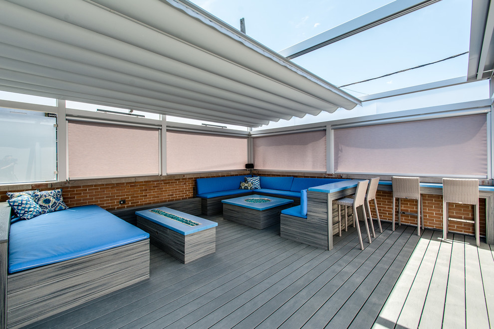 Design ideas for an expansive modern rooftop deck in Chicago with a water feature and a pergola.