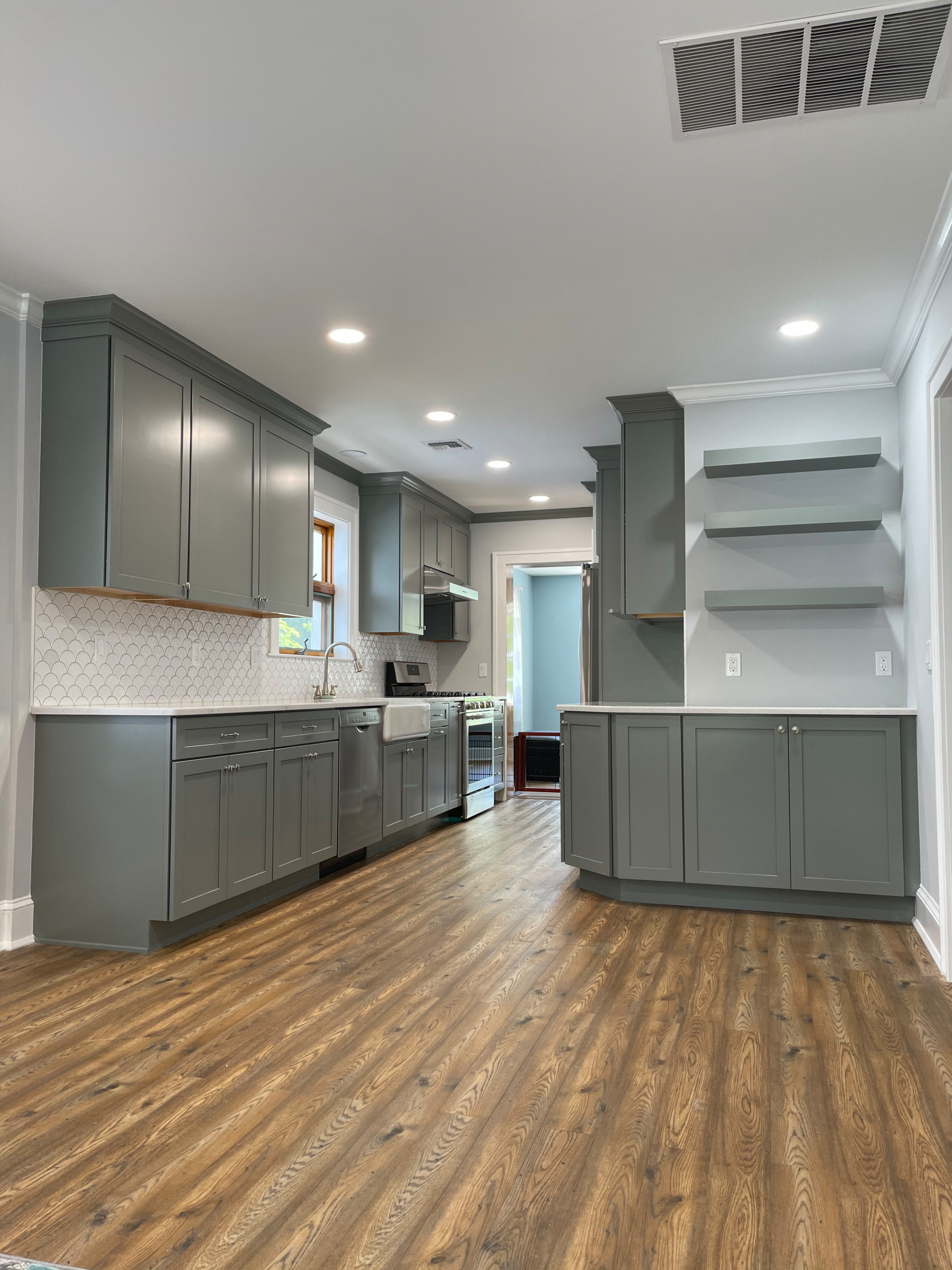This kitchen has a fresh and casual feeling . Grey cabinets adds unique flare